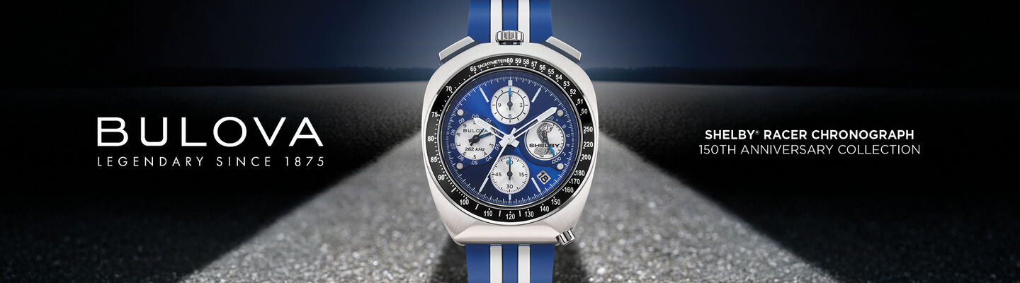 Bulova Limited Edition Shelby Racing Chronograph watch with blue and white racing stripe strap displayed on a road background.
